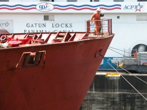 The cables at the bow of the ship are attached to mules which stabelize the ship as it passes through the canal.