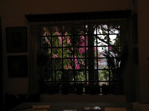 View of monastery gardens through glass door.